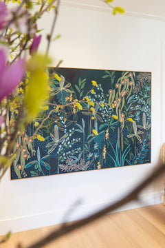 Framed botanical artwork with flowers in the foreground